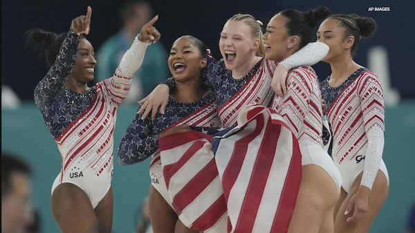 The US olympic gymnastics team in a victory embrace
