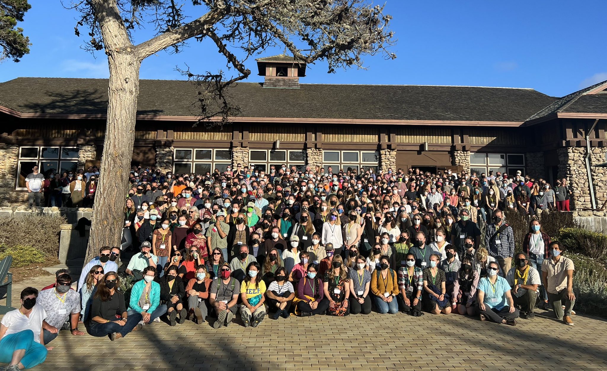 Photo of attendees at the 2022 LTER All Scientists' Meeting standing on steps in front of the main hall of the conference building